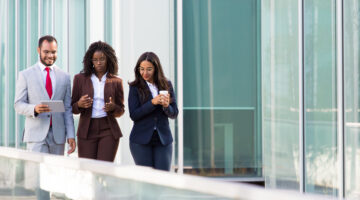 Three colleague walking towards a building